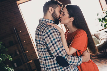 Photo of happy young couple move new place enjoy live together kissing new apartment room light house flat indoor