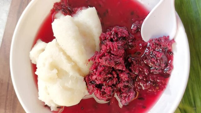 Uli tape is a traditional Indonesian food. Tape is made from fermented rice. Uli is made from cooked rice and mashed. It is eaten by mixing tape and uli.