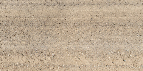view from above on texture of dry road with tractor tire tracks in countryside