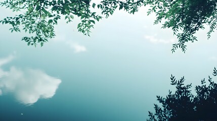 Obraz premium A minimalistic view of a tranquil lake reflecting the sky, surrounded by gentle greenery, with ample copy space