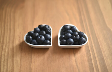 Blueberries in two heart-shaped bowls