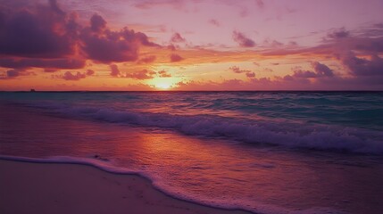 Obraz premium A vibrant sunset over the Caribbean coast, with gentle waves lapping at the shore, creating a serene atmosphere