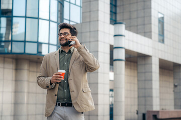 Energetic Young Businessman with Smartphone and Coffee Outdoors