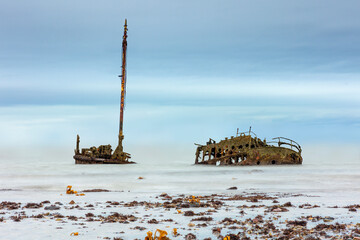 SS or MV Kaffir Clyde puffer wreck rusting north of Ayr Harbour with seaweed foreground - Long...
