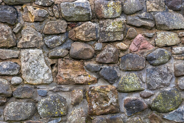 Old building random rough stone block and mortar wall background texture ideal graphic design element