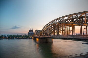 Fototapeta premium Hohenzollern Bridge and Cologne Cathedral in the background at sunset in Germany