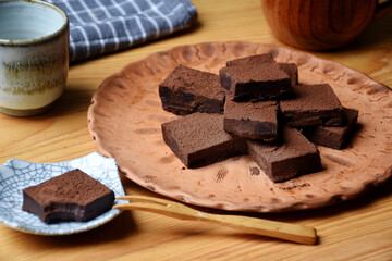 Japanese Nama Chocolate is a type of ganache, which is made from a mix of melted cacao and fresh cream. The block of chocolate cut into pieces and sprinkled with cocoa powder.