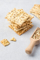 A stack of healthy fitness cookies with sesame seeds, flax seeds and sunflower seeds.