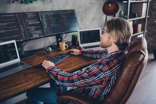 Photo of blond hair young professional it specialist sitting leather boss armchair programming engineer looking into pc display indoors office