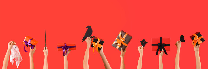 Women with Halloween gifts and decor on red background