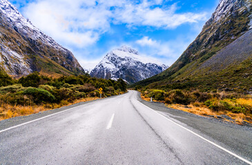 Amazing roads with snow capped mountains in the background