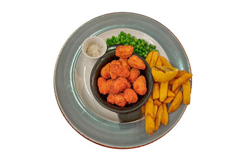 Golden deep fried scampi, chips, green peas, grilled lemon and tartare sauce on plate