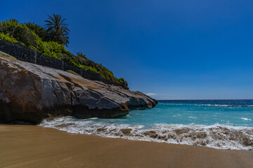 Fototapeta premium Yellow sand beach, dangerous high waves, rough Atlantic Ocean, famous Playa del Duque Teneriffe Costa Adeje