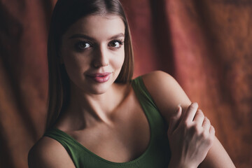 Photo no filter of charming stunning lady wearing top posing in studio over brown color background