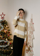 Portrait of a teenage girl near a wall advent calendar.