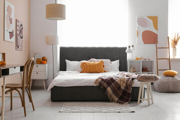 Interior of modern bedroom with autumn decor