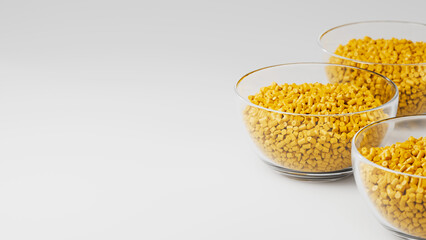 Glass cups with yellow plastic polypropylene granules, masterbatch polymer grain, on white backdrop. HDPE or PVC resin pellets. 3d render illustration