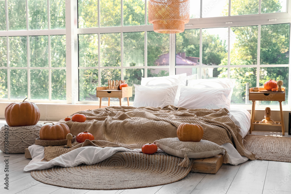 Poster Interior of light bedroom with bed, tables and pumpkins