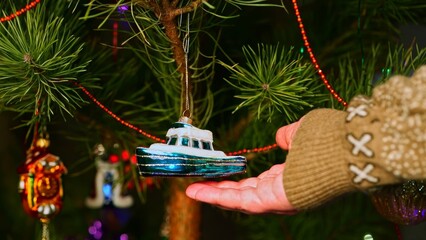 Boat, ship, yacht. Christmas tree toy decorations. New Year and Merry Christmas. Live christmas tree with garlands and toys.