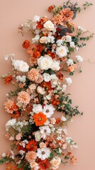 A colorful arrangement of various wildflowers is beautifully displayed on a soft pink background, creating a cheerful, seasonal flat lay perfect for inspiring designs or greeting cards