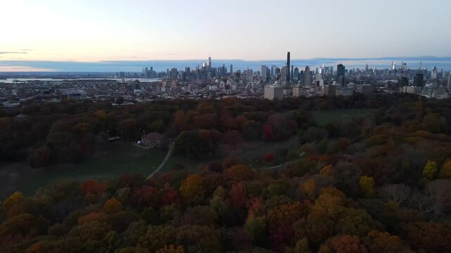 Aerial sunset landscape of Prospect Park in fall with Brooklyn Manhattan skyline New York City