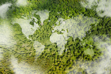 World map made of white puffy clouds on green forest. World environment day concept.