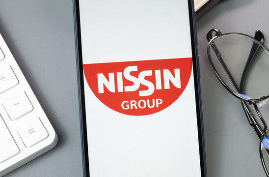 New York, USA - 30 August 2024: Nissin Group Logo on Phone Screen, Company Icon on Display