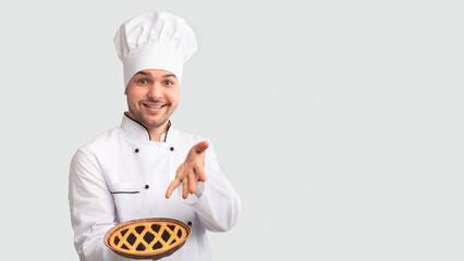 Cheerful Chef Man Showing Baked Pie Standing Over White Studio Background. Easy Culinary Recipes. Panorama