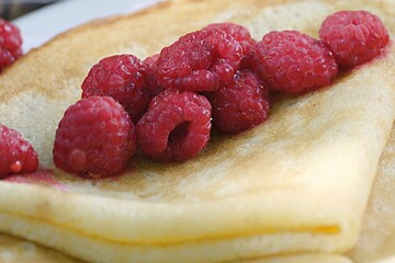 pancakes with red raspberries. bakery products