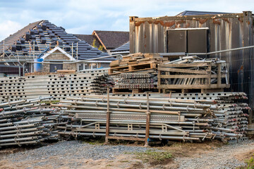 Metal scaffolding stored at side of new build housing building site