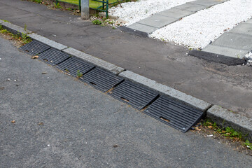 Six rubber kerb ramps at end of domestic driveway onto public road