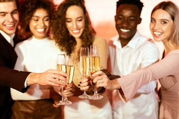 Celebrating Xmas. Cheerful Colleagues Clinking Glasses Toasting With Champagne On Christmas Corporate Party Indoors