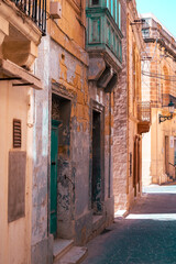 Fototapeta premium Old ruined facade buildings in the beautiful old town of touristic Gozo, Malta Island