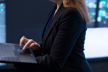 Computer scientist in server room using laptop to implement and maintain security measures, protecting systems from unauthorized access. Close up of data center worker doing hardware upgrades