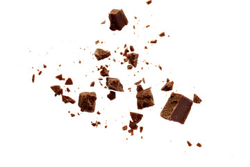 Broken chocolate pieces on white background.Chocolate chips . Ingredients for dessert...
