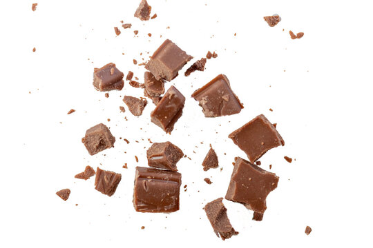 Broken milk chocolate pieces on white or transparent background.Chocolate chips . Ingredients for dessert recipes.Recipe magazines and cookbooks 