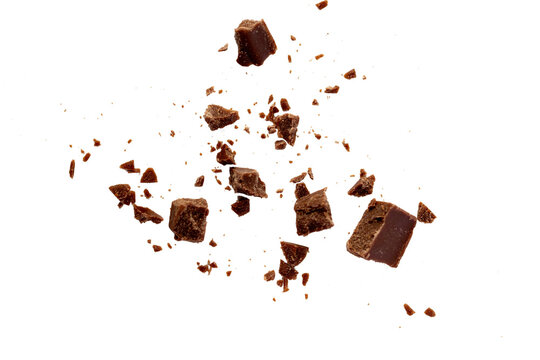 Broken chocolate pieces on white background.Chocolate chips . Ingredients for dessert recipes.Recipe magazines and cookbooks 