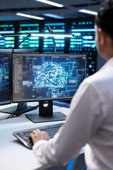 System administrator working in data center providing computing resources needed for artificial intelligence to process massive datasets. IT expert in server hub storing data used for machine learning