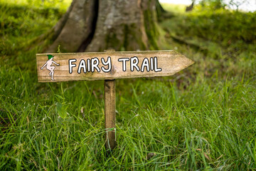 Fairy Trail direction arrow sign on post pointing to fairy corner in woodland