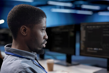 Engineer doing maintenance in data center facility to extend equipment life span and avoid downtime. Close up shot of IT expert monitoring servers for issues such as overheating or power fluctuations