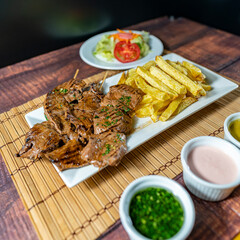 heart anticucho with french fries, strawberry salad, homemade creams and a glass of wine