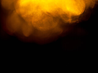 Light orange warm color light leak on dark background for design use and special effects. Abstract shape.