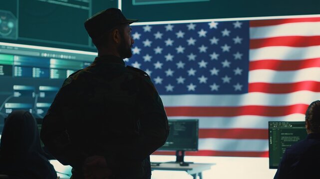 American military personnel ensuring servers protection and classified information, protecting state secrets in high tech agency office. Army soldier supervises hacking activity. Camera A.