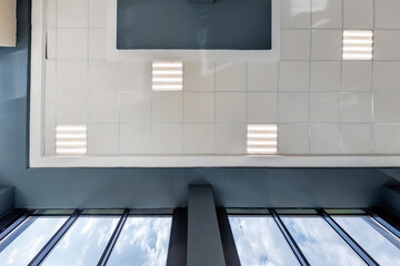 cassette stretched or suspended ceiling with square halogen spots lamps and drywall construction in...