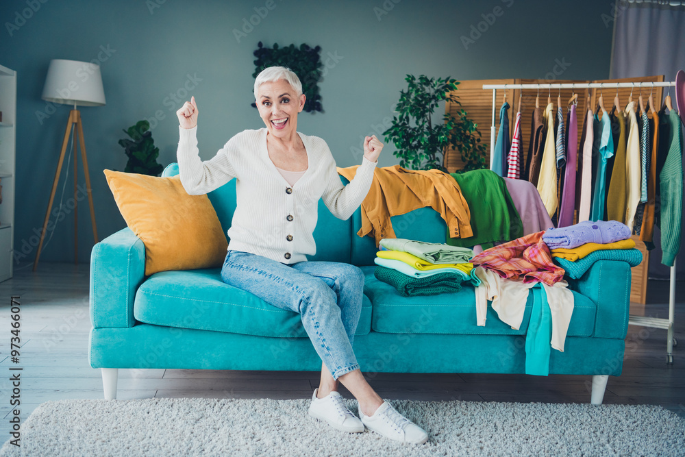 Poster Photo of charming attractive retired woman dressed white cardigan home chores tidy clean clothes indoors