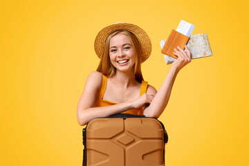 Happy girl tourist lean on suitcase and holding flight tickets and map, ready to travel, posing...
