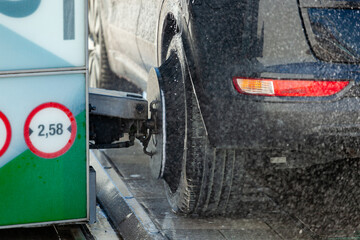 Modern car wash station is cleaning a vehicle during winter time