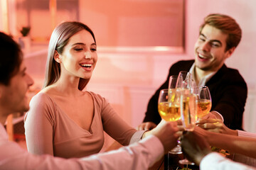 Christmas Corporate Party. Happy Coworkers Clinking Glasses Toasting During Xmas Celebratory Dinner Sitting In Restaurant. Selective Focus
