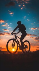 Obraz premium Person’s Silhouette Cycling on Bicycle Under Twilight Sky