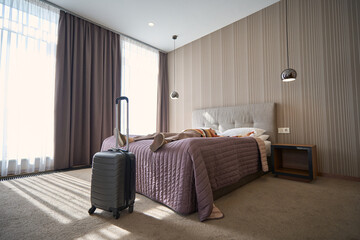 Adult woman lying on the bed resting after checking into hotel room